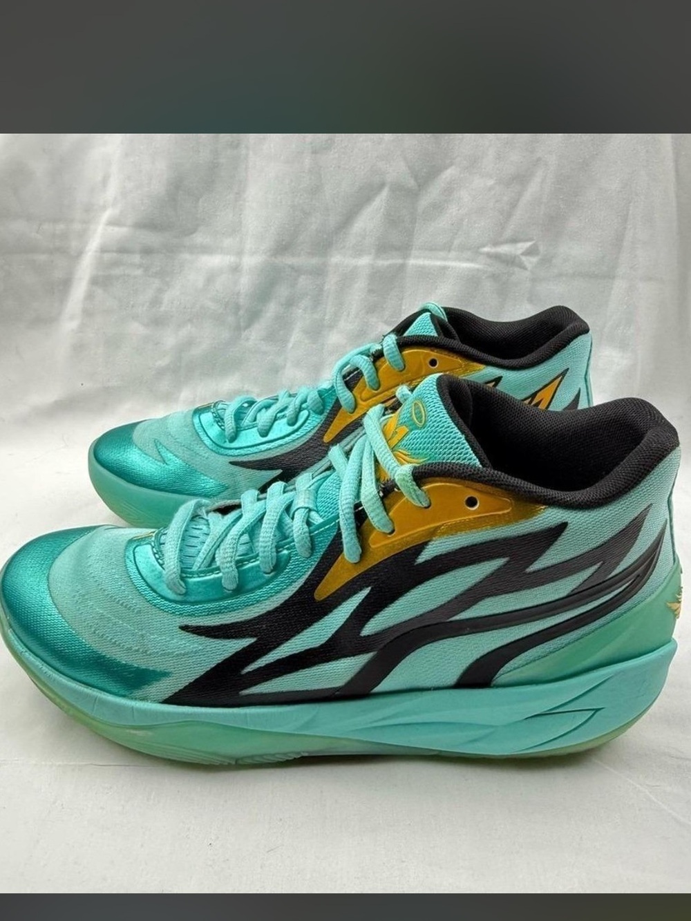 Puma MB.02 "Honeycomb" basketball sneakers in an Elektro Aqua and black 8.5